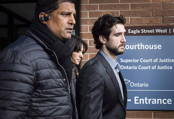 Marco Muzzo, right, leaves the Newmarket courthouse surrounded by family, on February 4, 2016. THE CANADIAN PRESS/Christopher Katsarov