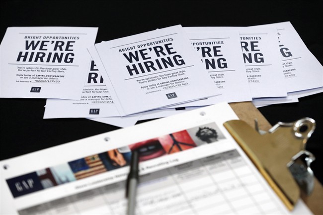 In this Tuesday, Oct. 6, 2015, file photo, job applications and information for the Gap Factory Store sit on a table during a job fair at Dolphin Mall in Miami.