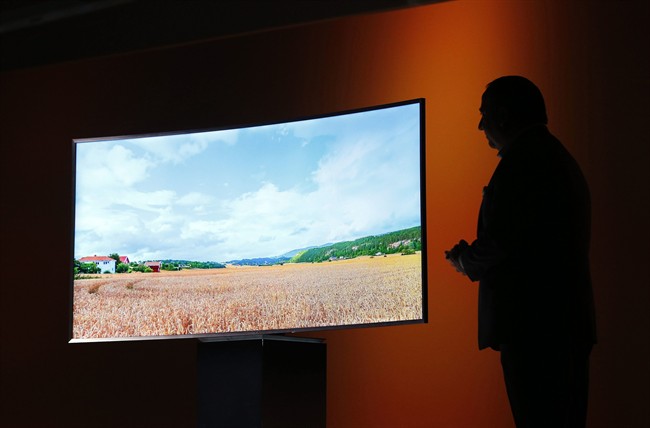 In this Jan. 5, 2015, file photo, Joe Stinziano, executive vice president of Samsung Electronics America, introduces a Samsung SUHD 4K TV at a news conference in Las Vegas.