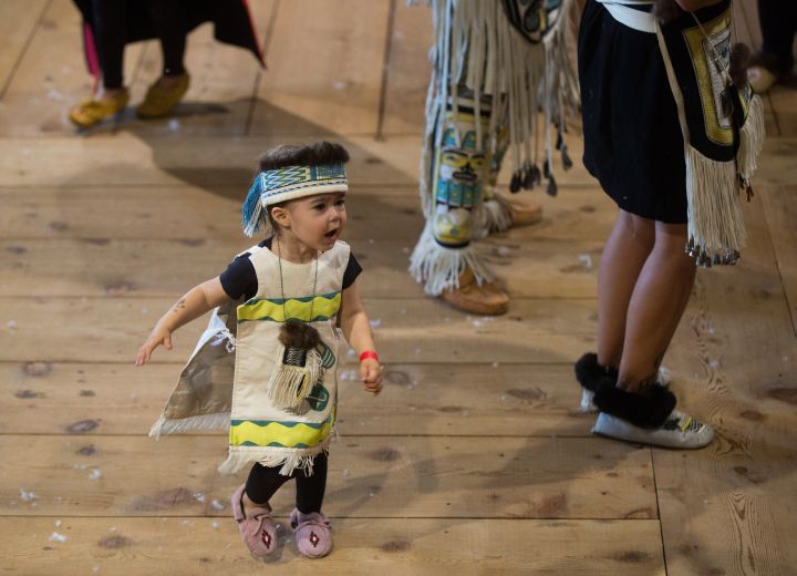 A young girl from the Haida First Nation dances during a welcoming ceremony for the Duke and Duchess of Cambridge at the Haida Heritage Centre and Museum in Haida Gwaii, B.C., on Friday Sept. 30, 2016.