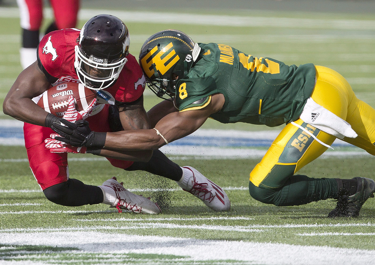Calgary Stampeders DaVaris Daniels (89) is tackled by Edmonton Eskimos Cauchy Muamba (8) during first half CFL action in Edmonton, Alta., on Saturday September 10, 2016.