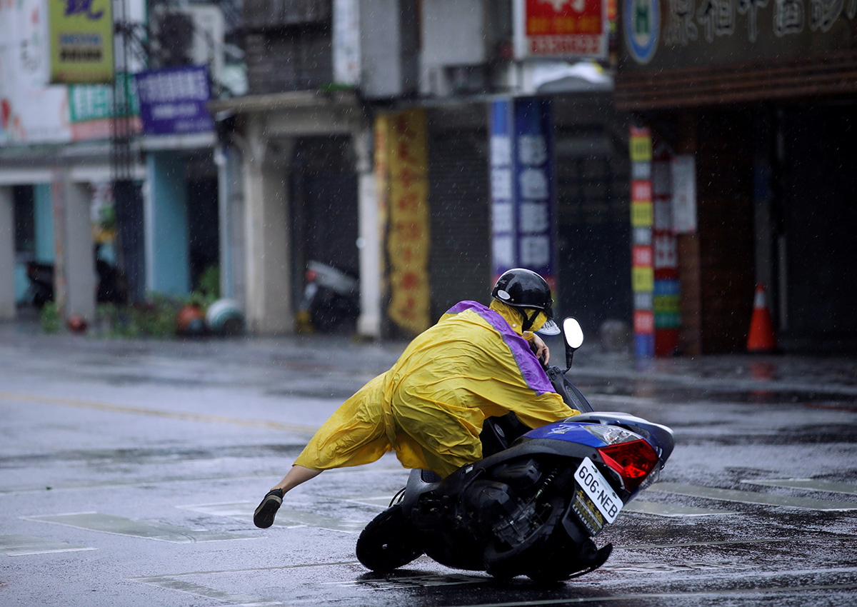 A motorcyclist falls along a road as Typhoon Megi hits Hualien, eastern Taiwan, September 27, 2016.