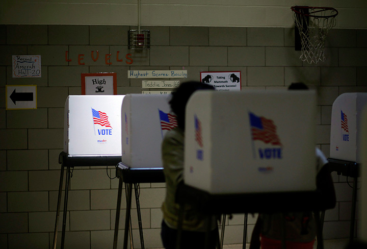 Sunlight shines through a window onto a voting booth at a polling place.