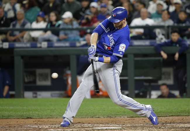 Toronto Blue Jays' Michael Saunders hits a two-run home run in the fourth inning of a baseball game, Tuesday, Sept. 20, 2016, in Seattle. Blue Jays' Troy Tulowitzki scored on the play.