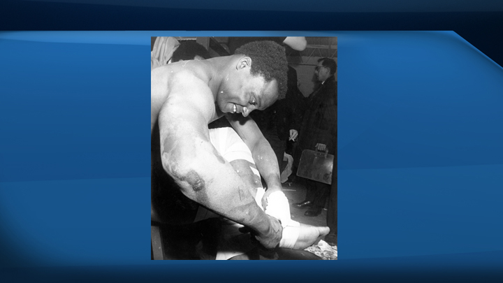 George Reed of the Saskatchewan Roughriders grimaces as he pulls tape from his ankle in the dressing room following the Grey Cup game in Ottawa in 1967.