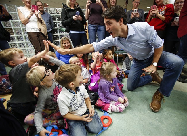 Prime Minister Justin Trudeau high fives pre-schoolers at Medicine Hat College in Medicine Hat, Alta., Friday, Oct. 14, 2016.