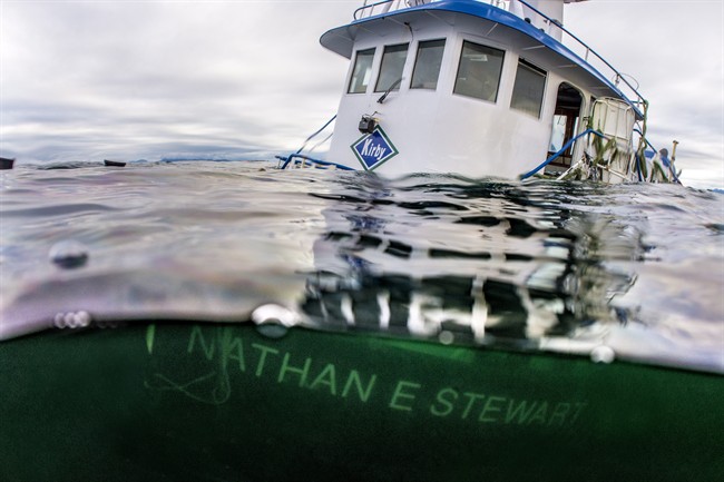 The sinking of a tug and the subsequent diesel spill on British Columbia's central coast is prompting a rethink to emergency response that could allow those closest to the disaster to take the lead, says the federal indigenous affairs minister. The tug boat Nathan E. Stewart is seen in the waters of the Seaforth Channel near Bella Bella, B.C., in an October 23, 2016, handout photo.