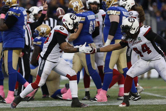 Ottawa Redblacks' Damaso Munoz (45) and Taylor Reed (44) celebrate Munoz's sack of Winnipeg Blue Bombers quarterback Matt Nichols (15) during the second half of CFL action in Winnipeg Saturday, October 29, 2016.