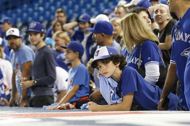 Toronto Blue Jays fans look on after the Cleveland Indians defeated the Blue Jays in game five American League Championship Series baseball action in Toronto on Wednesday, October 19, 2016.