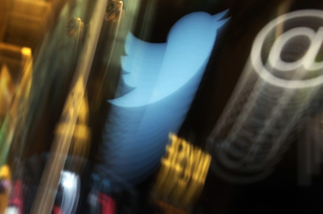 In this  Nov. 6, 2013, file photo, the Twitter logo appears on an updated phone post on the floor of the New York Stock Exchange. 