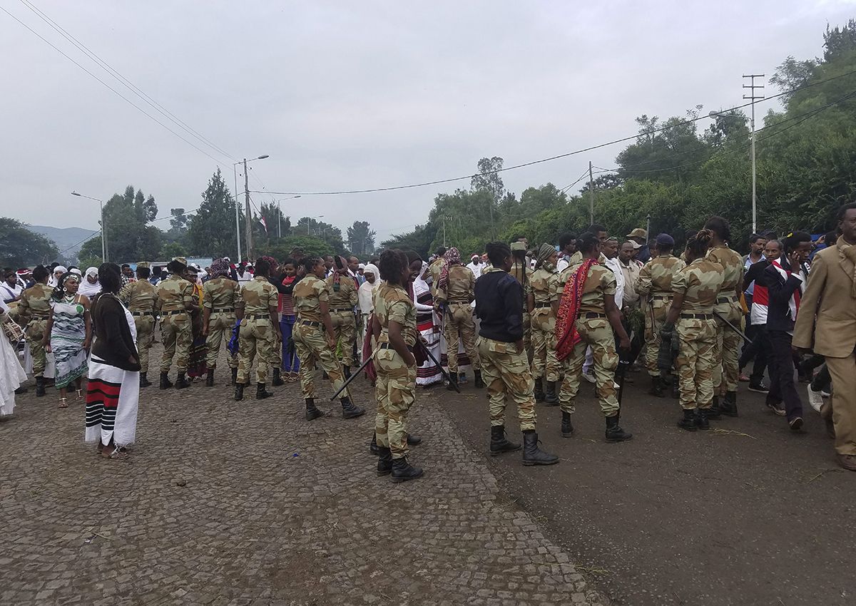 Ethiopian soldiers block the street as people march during an annual religious festival in Bishoftu, a town southeast of Ethiopia’s capital, Addis Ababa, Sunday, Oct. 2, 2016.