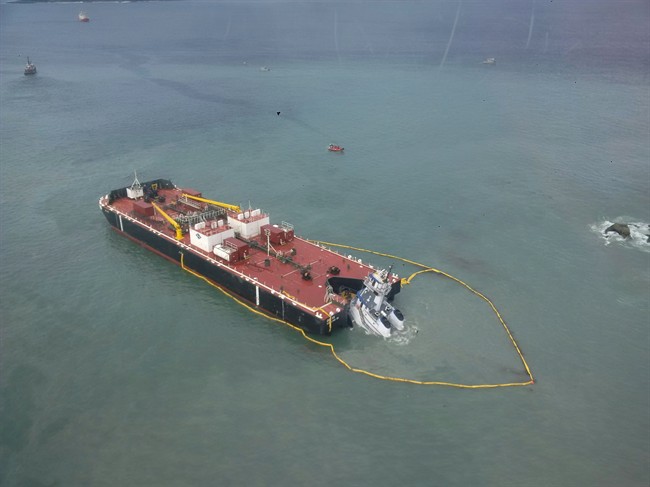 The tugboat Nathan E. Stewart lies submerged at the mouth of the Seaforth Channel near Bella Coola, B.C., shown in a handout photo from the Canadian Coast Guard.
