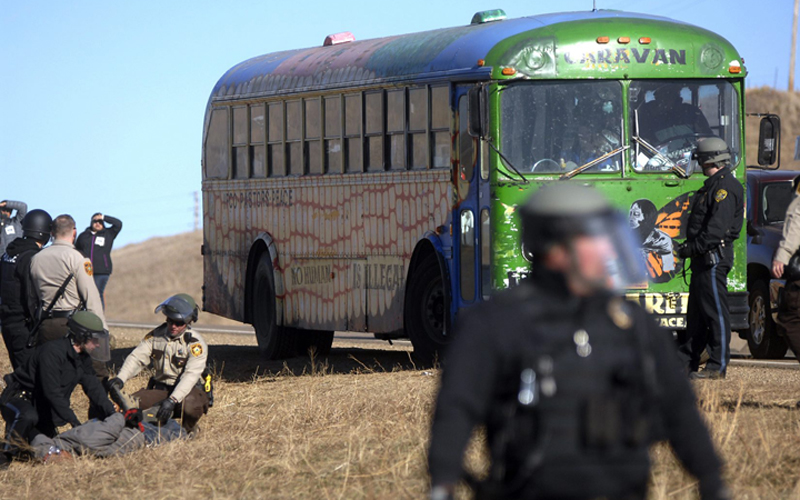 Law enforcement officers arrest a Dakota Access Pipeline protester, far left, during a clash at a pipeline construction site south of St. Anthony, N.D. Friday, Nov. 11, 2016.