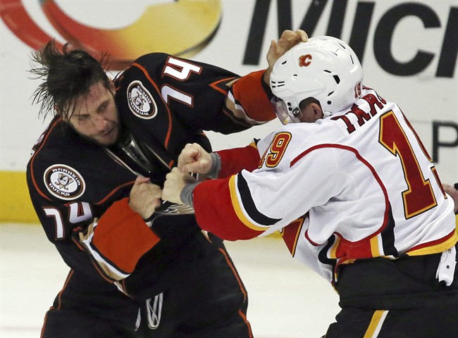 Anaheim Ducks left winger Joseph Cramarossa (74) and Calgary Flames left winger Matthew Tkachuk (19) fight in the second period of an NHL hockey game in Anaheim, Calif., Sunday, Nov. 6, 2016. 