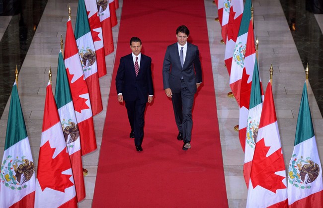 Prime Minister Justin Trudeau and Mexican President Enrique Pena Nieto walk down the Hall of Honour on their way to a signing ceremony on Parliament Hill in Ottawa on Tuesday, June 28, 2016.