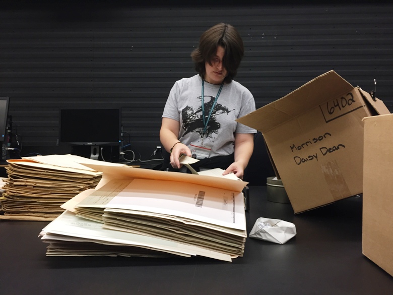 An employee at Library and Archives Canada sorts files from the First World War at the archival centre in Gatineau.