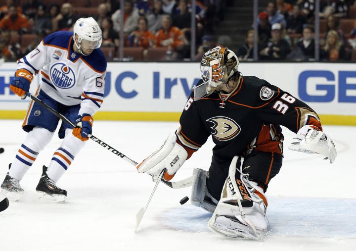 Anaheim Ducks goalie John Gibson, right, blocks a shot by Edmonton Oilers left wing Benoit Pouliot during the first period of an NHL hockey game in Anaheim, Calif., Tuesday, Nov. 15, 2016. 
