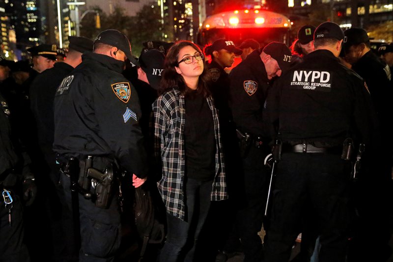 A woman is detained during a protest outside the Trump International Hotel and Tower following President-elect Donald Trump’s election victory in Manhattan, New York, U.S., November 9, 2016. REUTERS/Andrew Kelly