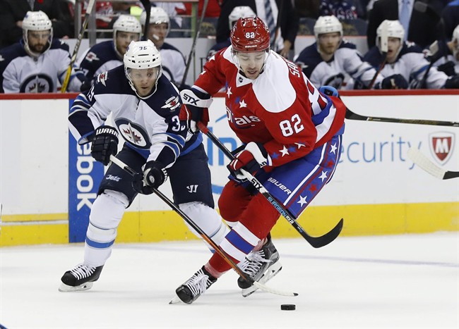 Winnipeg Jets defenseman Toby Enstrom (39) defends against Washington Capitals center Zachary Sanford (82) in the first period of an NHL hockey game, Thursday, Nov. 3, 2016, in Washington.