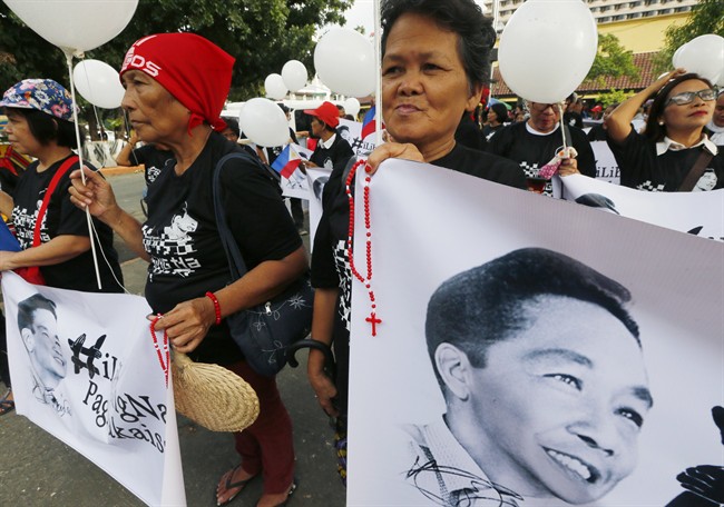 Supporters of the late Philippine dictator Ferdinand Marcos display his images prior to marching towards the Supreme Court for an overnight vigil Monday, Nov. 7, 2016 in Manila, Philippines. 