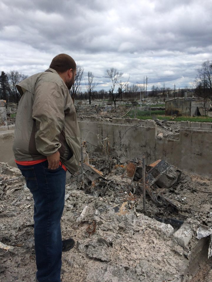 Fort McMurray resident Chris Flett surveys what’s left of his home following the May wildfires