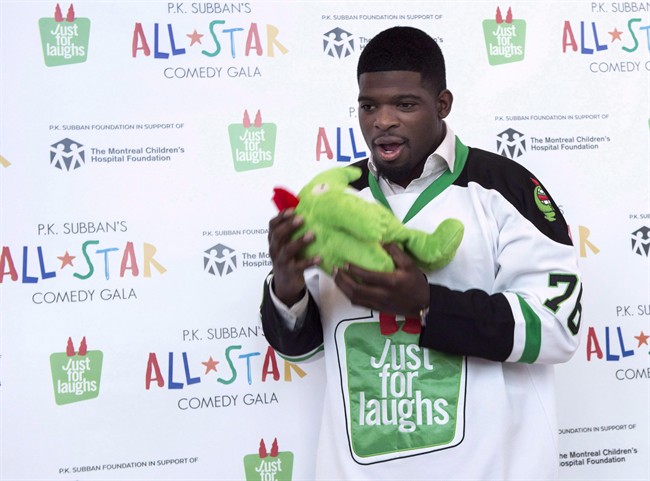 Nashville Predators defenceman P.K. Subban hams it up with a stuffed mascot during a news conference in advance of the P.K. Subban All-Star Comedy Gala, Monday, August 1, 2016 in Montreal.