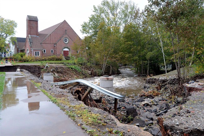FILE: A washed out road and damaged guard rail is shown in Sydney, N.S., Tuesday, Oct.11, 2016. The estimated cost for damage caused by the Thanksgiving Day floods in Cape Breton could exceed $15 million, says the Nova Scotia government.