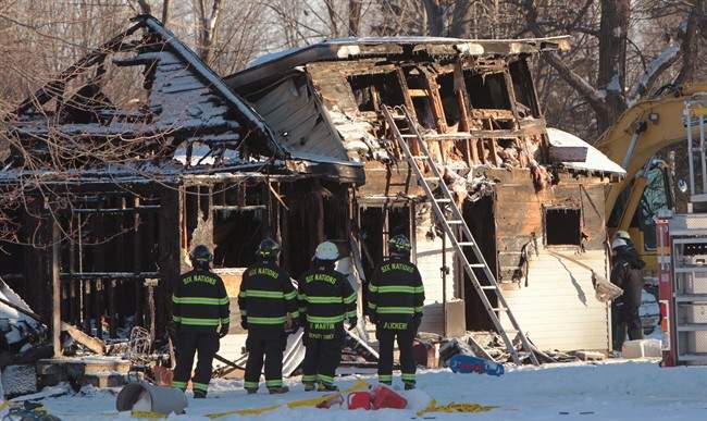 Firefighters and Ontario fire marshal officials attend the scene of a house fire on Oneida Nation of the Thames, southwest of London, Ont., Thursday Dec. 15, 2016.