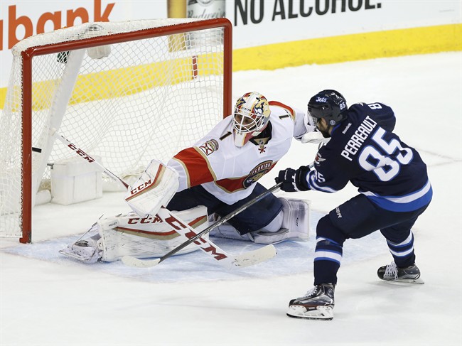 Winnipeg Jets' Mathieu Perreault scores the shootout winner against Florida Panthers goaltender Roberto Luongo on Dec. 15, 2016.
