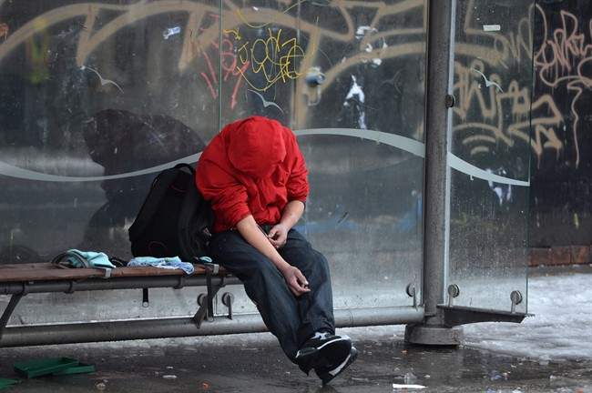 FILE PHOTO: A man injects himself at a bus shelter in Vancouver's Downtown Eastside, Monday, Dec.19, 2016.