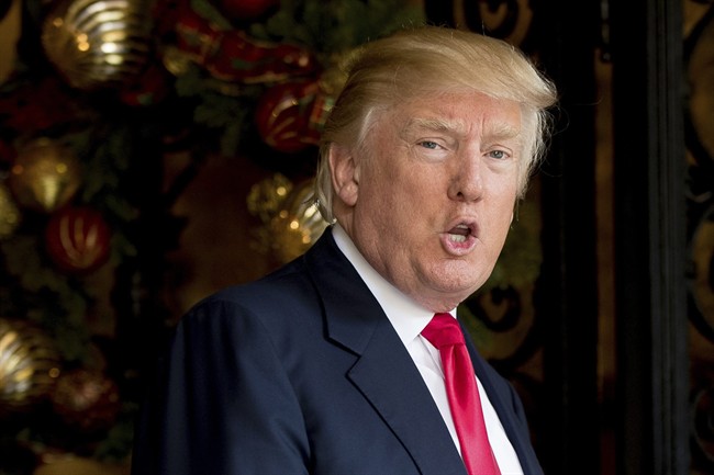In this Dec. 21, 2016, file photo, President-elect Donald Trump speaks to members of the media at Mar-a-Lago, in Palm Beach, Fla. 