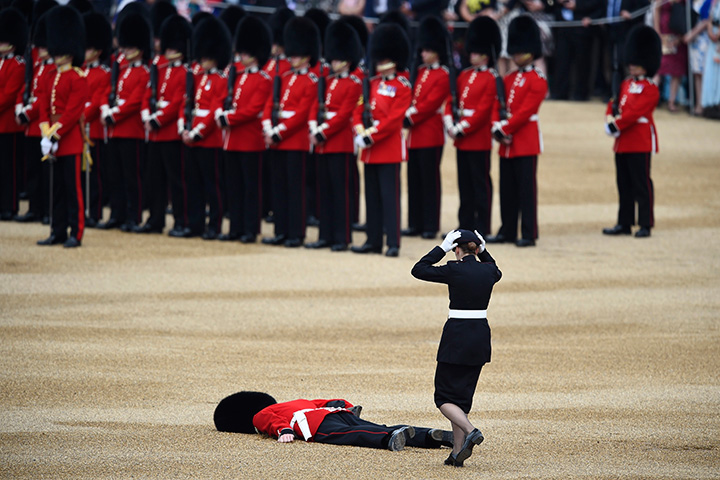 A Guardsman faints during the annual Trooping the Colour ceremony in central London, England on June 11, 2016.
