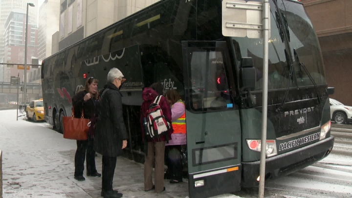 Passengers boarding a Red Arrow bus for holiday travel.