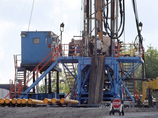 FILE - In this June 25, 2012 file photo, a crew works on a gas drilling rig at a well site for shale based natural gas in Zelienople, Pa. 
