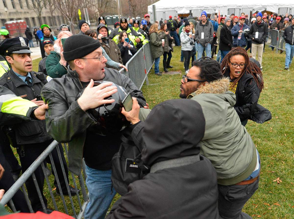 Protesters attack a man trying to pass at an entry point prior at the inauguration of President-elect Donald Trump in Washington. REUTERS/Bryan Woolston
