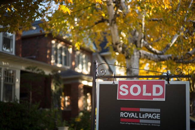 A real estate sold sign hangs in front of a west-end Toronto property Friday, Nov. 4, 2016. Toronto-area house prices continued to soar in December, and sales volume was up 8.6 per cent over the same month in 2015. 