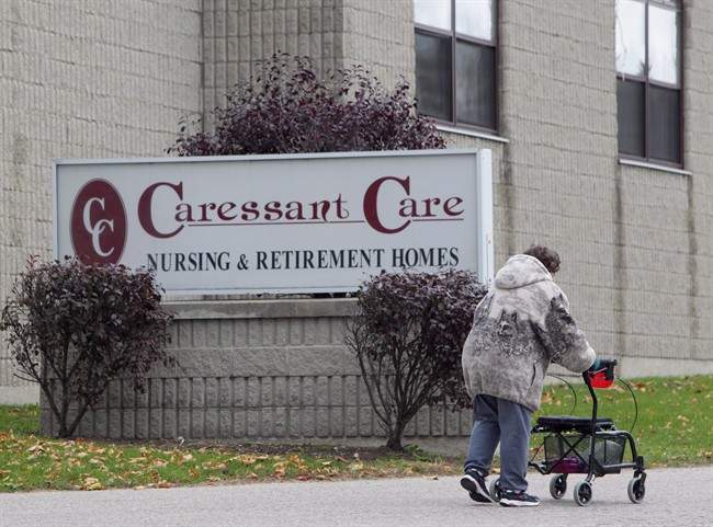 A woman walks into the Caressant Care facility in Woodstock, Ont., on Tuesday, Oct. 25, 2016.
