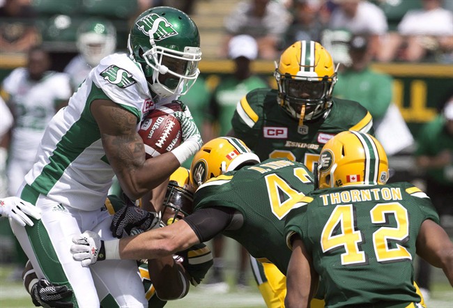 Saskatchewan Roughriders Shamawd Chambers (17) is surrounded by Edmonton Eskimos during first half CFL pre-season action in Edmonton, Alta., on Saturday June 18, 2016. Receiver Shamawd Chambers, who was the top Canadian in the 2015 Grey Cup game, was among four veteran players released Friday by the Saskatchewan Roughriders.
