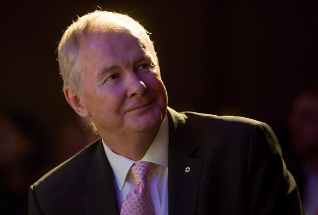 John Furlong, Own The Podium board chairman and former CEO of the Vancouver Olympics, watches a video of 2010 Olympic moments before addressing a Vancouver Board of Trade luncheon in Vancouver, B.C., on Wednesday November 25, 2015. Furlong will be back at the podium for a University of British Columbia fundraising event after the abrupt cancellation of his speech and subsequent apology from the university.