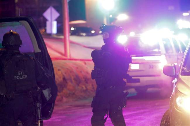Police survey the scene of a shooting at a Quebec City mosque on Sunday January 29, 2017.
