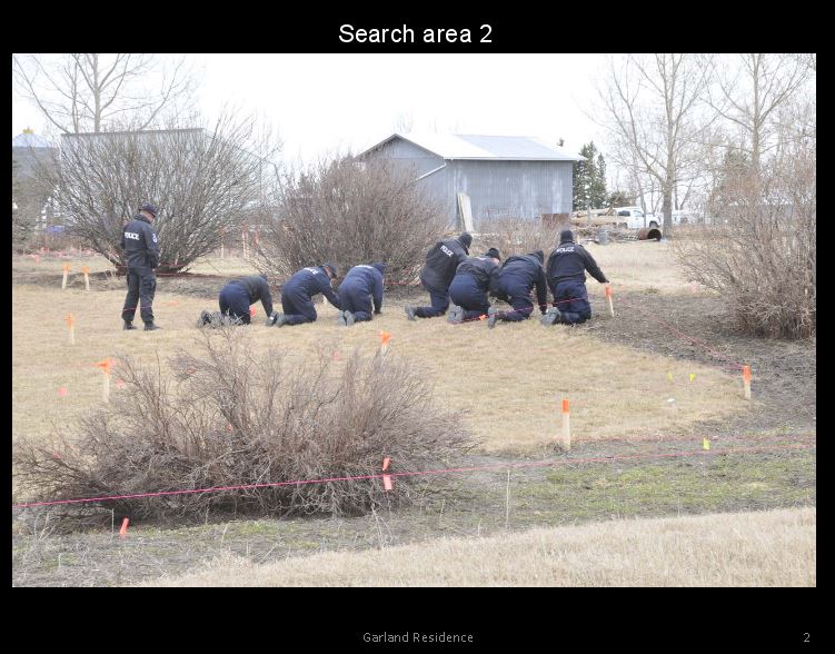Officers searching the Garland property. Photo presented as evidence Jan. 25, 2017.