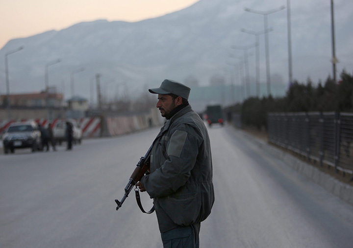 A member of the Afghan security forces stands guard near the site of two blasts in Kabul, Afghanistan, Tuesday, Jan. 10, 2017. 