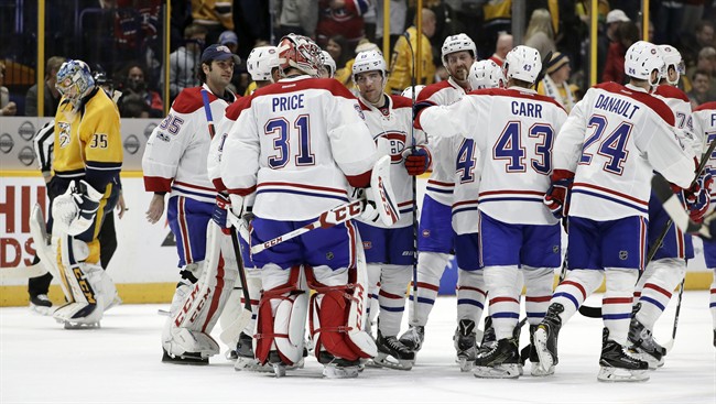 Montreal Canadiens players celebrate with goalie Carey Price (31) as Nashville Predators goalie Pekka Rinne, left, of Finland, skates to the bench after the Canadiens beat the Predators 2-1 in overtime at an NHL hockey game Tuesday, Jan. 3, 2017, in Nashville, Tenn.