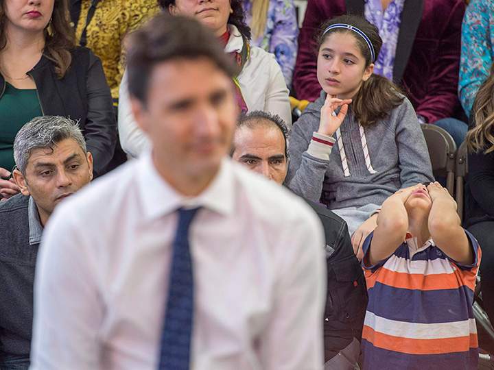 A young boy attends a town hall meeting with Prime Minister Justin Trudeau in Fredericton on Jan. 17, 2017. How did other Canadians feel about the tour?.