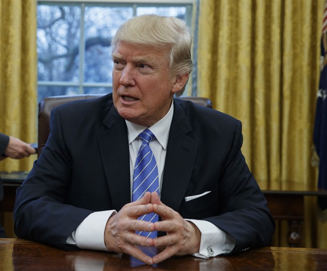 In this Jan. 23, 2017 file photo, President Donald Trump sits at his desk in the Oval Office of the White House in Washington.
