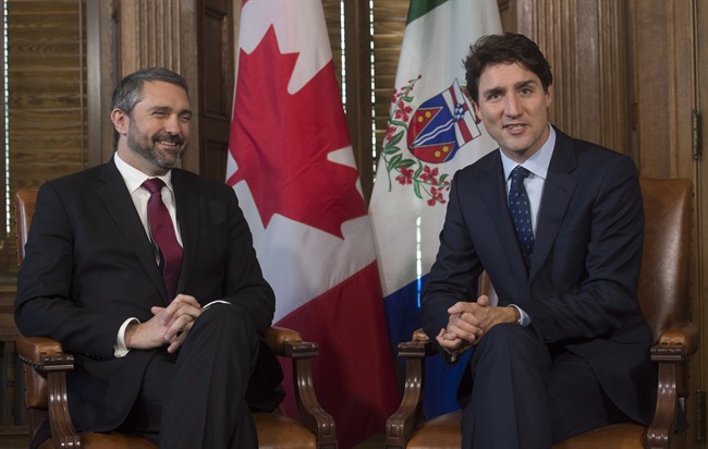 Yukon Premier Sandy Silver smiles as he listens to Prime Minister Justin Trudeau before a meeting in the prime minister's office on Parliament Hill, Wednesday, February 8, 2017 in Ottawa. THE CANADIAN PRESS/Adrian Wyld.