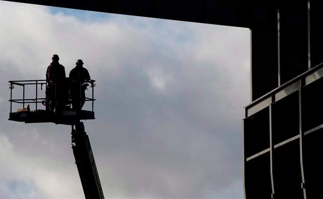 Workers are pictured at the Vancouver Shipyard in an October 7, 2013, file photo. 