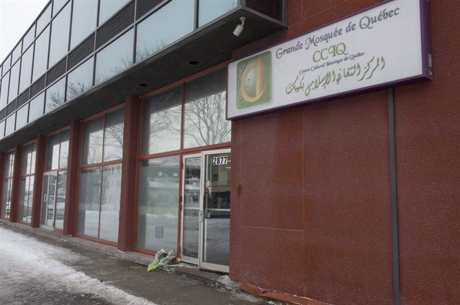 In this Feb. 2017 file photo, flowers lay at the men's entrance of the Quebec City mosque where six men were fatally shot as they attended evening prayers.