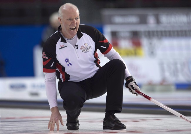 Team Ontario skip Glenn Howard reacts to his shot entering the house during round robin competition against Team PEI at the Brier curling championship, Wednesday, March 9, 2016 in Ottawa. 