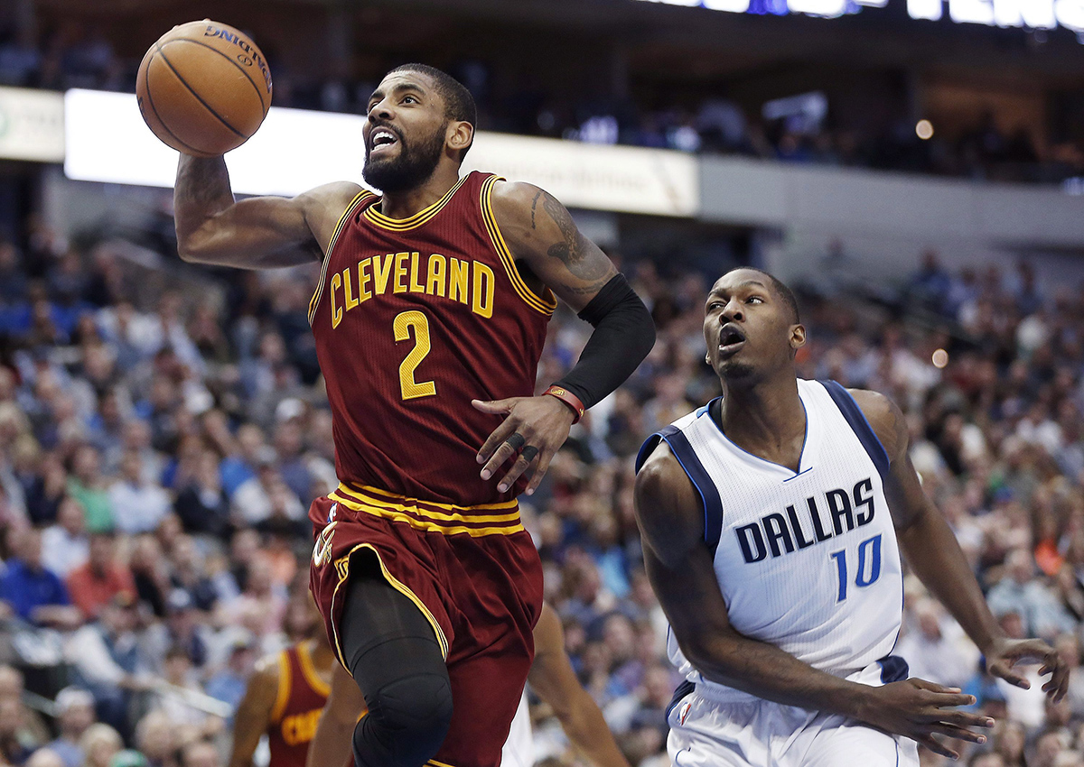 Cleveland Cavaliers guard Kyrie Irving (2) battles past Dallas Mavericks guard Yogi Ferrell (10) for a layup during the first half of an NBA basketball game, Monday, Jan. 30, 2017, in Dallas. 
